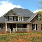 Front view of brick house with dark roof